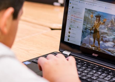 Boy learning and having fun with Classcraft on his laptop